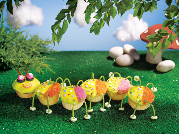 A Cupcake Caterpillar crawling on a strip of astroturf.