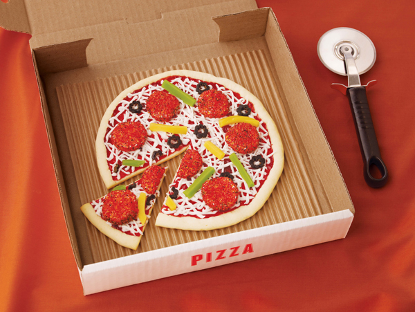 A cookie pizza complete with candy "pepperoni" slices in its own little pizza box.
